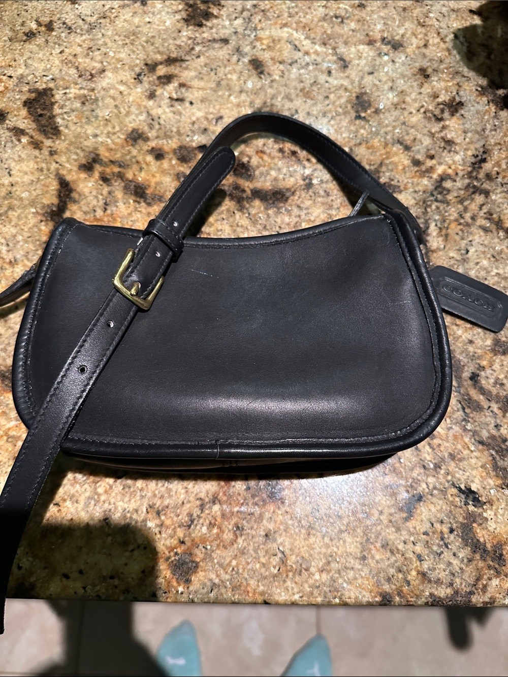 Vintage small black Coach crossbody bag.